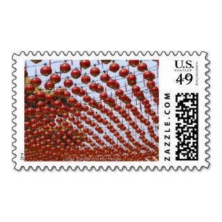 Many red Chinese lanterns hanging above Postage Stamps