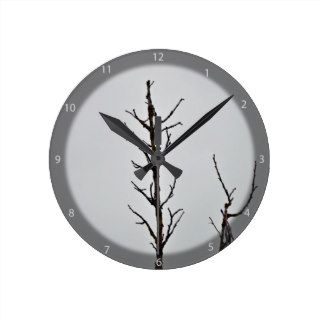 Bare tree branches against a cloudy sky clock