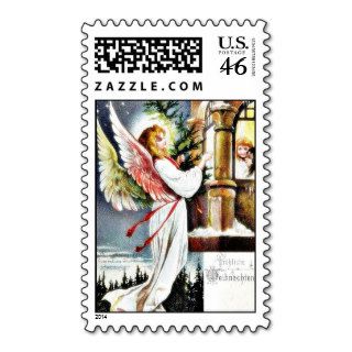 An angel comes down with christmas tree on hand an postage stamps