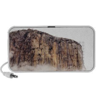 Sheer cliff rising above clouds portable speaker