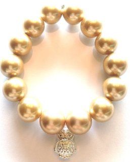 Jubel & Stern, noble golden shell bead stretch bracelet (about 14 mm) with silver owl pendant. Length about 19 ??cm. Made in Germany Jewelry