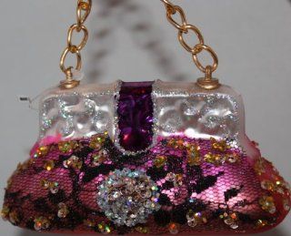 December Diamonds Fun Pink Blown Glass Purse Ornament Hanging from Gold Link Chain.Perfect Ornament for the Woman in Your Life who loves Purses.Fun Hand Blown Glass Ornament has been Discontinued.Approximately 2 1/2 inches Tall. Front of the Ornament has B