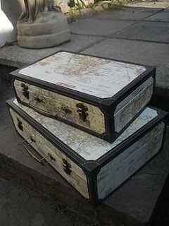 set two world map suitcases by the hiding place