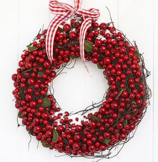 large cranberry christmas wreath by the contemporary home