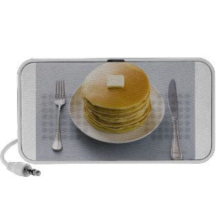 Stack of pancakes with butter on a plate notebook speakers