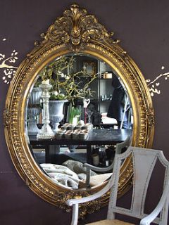 large ornate oval gold mirror by figa & co. ltd