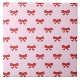 Pattern of nice red bows on pretty pink background ceramic tile
