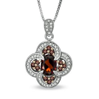 Oval Garnet and 1/3 CT. T.W. Enhanced Red and White Diamond Pendant in